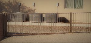 Outdoor air conditioning units behind metal fence